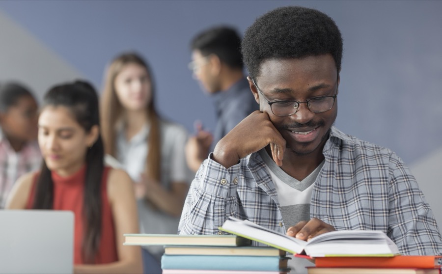 A student reading in a classroom